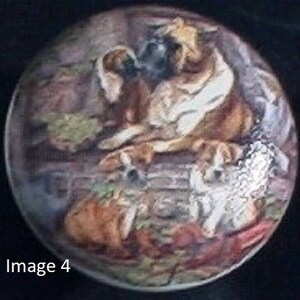 May include: A round decorative object featuring a painted scene of several dogs. The dogs are depicted in shades of brown, white, and tan, with a detailed, artistic style. The text "Image 4" is visible at the bottom.