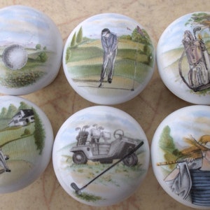 May include: Six round ceramic knobs with golf-themed illustrations. The knobs feature a golfer, a golf cart, a golf bag, and a golf ball.