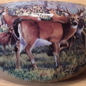 May include: White ceramic decorative handle featuring a detailed illustration of deer in a forest setting. The artwork depicts several deer, including a buck with antlers, in a naturalistic landscape with trees and grass.