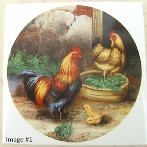 May include: A ceramic tile featuring a detailed painting of a rooster with vibrant red, yellow, and black plumage, a hen, and a chick. The artwork is set in a rural scene with a rustic aesthetic, evoking a farm theme.