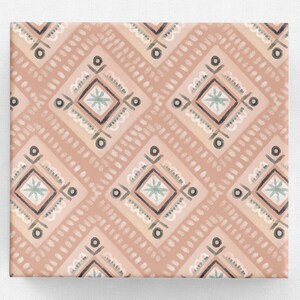 May include: A patterned fabric with a repeating design of diamonds and dots in shades of peach, gray, and white. The diamonds contain a star-like design in the center. The fabric is likely used for home decor or crafting.
