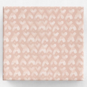 May include: A square, blush-colored surface with a repeating pattern of white brushstrokes. The brushstrokes form an X-like shape, creating a textured, abstract design. The lower right corner features a white banner with the text "fineapple graphics".