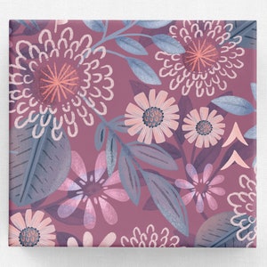 May include: A seamless pattern featuring a repeating design of pink and blue flowers and leaves on a deep purple background.