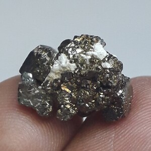 May include: A cluster of small, metallic, gold-colored pyrite crystals. The crystals are rough and have a natural, unpolished look.