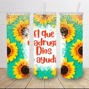 May include: Three turquoise tumblers with a sunflower pattern and gold glitter. The middle tumbler has the text "El que adruga Dios ayuda" in orange.