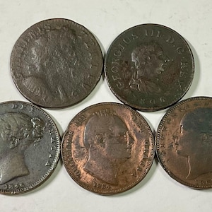 May include: Five antique coins of varying sizes and colours are displayed. The coins feature profiles of historical figures and inscriptions. The coins are made of copper and bronze, with visible signs of age and wear.