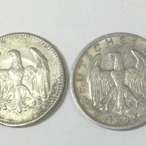 May include: Two silver German coins with the year 1925 on the reverse and a German eagle on the obverse.
