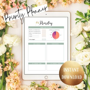 May include: A digital wedding planner displayed on a tablet, surrounded by flowers. The planner includes sections for budget, priorities, and contributions. Text on the screen reads "Priorities" and "Instant Download."