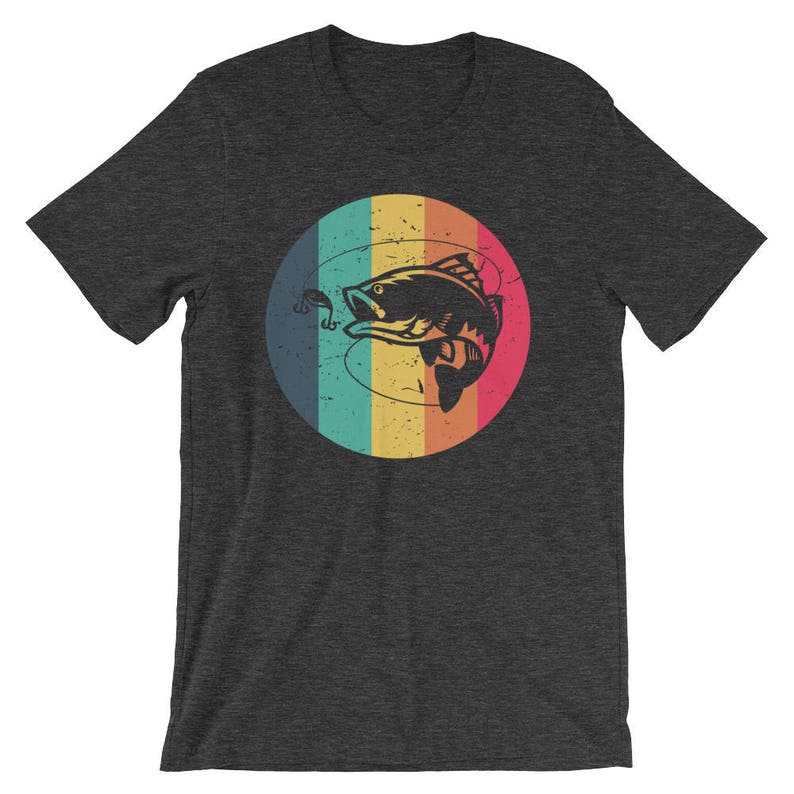 May include: A dark grey t-shirt with a retro-style graphic of a fish on a hook. The fish is in a circle with a rainbow background.