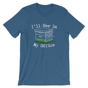 May include: A blue t-shirt with the text "I'll Bee In My Office" and a cartoon image of a beehive with bees flying around it.