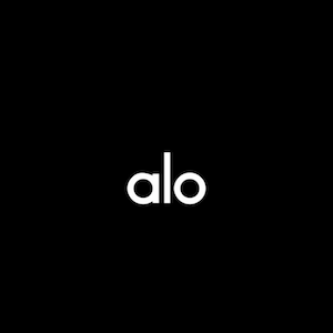 May include: The word "alo" in a clean, sans-serif font is centred on a black background. The letters are white and evenly spaced, creating a minimalist and modern aesthetic. The image is simple and bold.