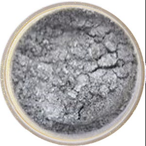 May include: A small round container of silver glitter makeup. The glitter is loose and has a slightly textured appearance.