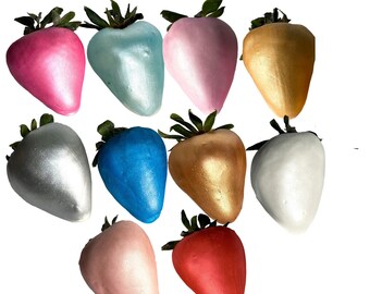 May include: Ten chocolate-covered strawberries, each dipped in a different color of shimmery metallic paint. The colors include pink, blue, gold, silver, white, red, and green.