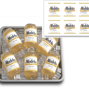 May include: A rectangular metal tray filled with clear ice cubes and five cans of Modelo Especial beer. An inset shows a white sheet containing six printed adhesive labels, each featuring the Modelo Especial logo and branding in gold and black.