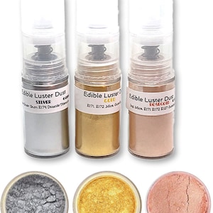 May include: Three bottles of edible luster dust in silver, gold, and rose gold. The bottles are labeled with the color and ingredients. The dust is also shown in small containers.