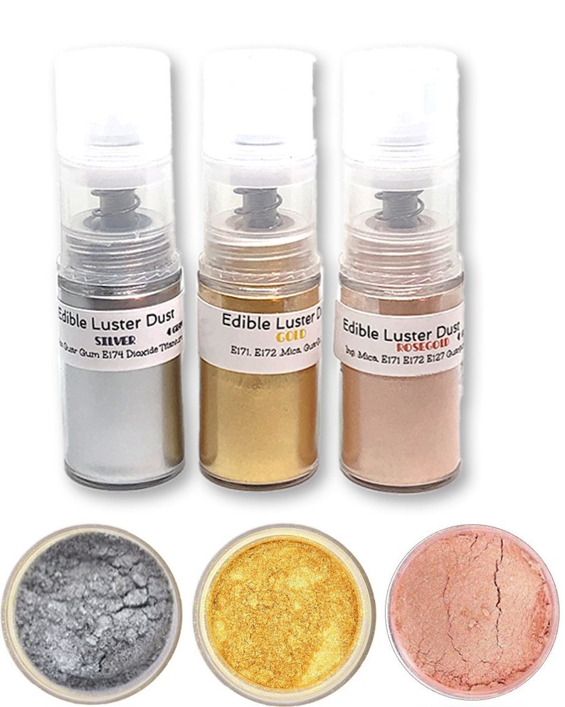 May include: Three bottles of edible luster dust in silver, gold, and rose gold. The bottles are labeled with the color and ingredients. The dust is also shown in small containers.