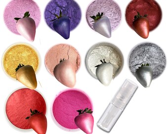 May include: Set of 10 metallic luster dusts in various colors, including gold, silver, pink, purple, and red. Each color is displayed in a small round container with a strawberry on top. A clear spray bottle is also included.