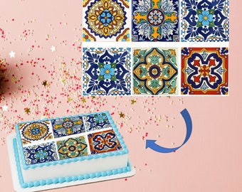 May include: A cake decorated with a colorful tile pattern. The cake is white with a blue border and is sitting on a pink surface. The tile pattern is made up of six different tiles, each with a unique design. The tiles are all in shades of blue, green, yellow, red, and white.