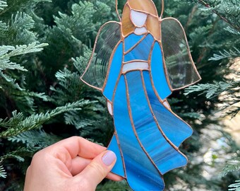 Stained glass Angel Celestial radiance Ethereal artistry Symbol of hope Gifts of love Artful decor Magical interiors Heavenly beauty grace