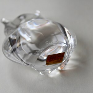 May include: Clear glass owl figurine with a textured surface. The owl has a label on the bottom that reads "Cristal France".