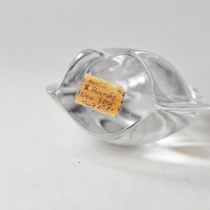 May include: A clear glass sculpture with a label that reads "Dunhill 5 Avenue New York Mail 7-11-59."