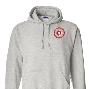 May include: A gray hooded sweatshirt with a red embroidered patch on the left chest. The patch features a red diamond with a castle inside and the text "20th Engineer Brigade Proudly Served".