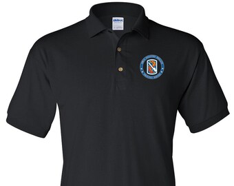 May include: Black polo shirt with an embroidered patch featuring the text "1st Infantry Division" and a graphic of a soldier holding a rifle and a burning torch.
