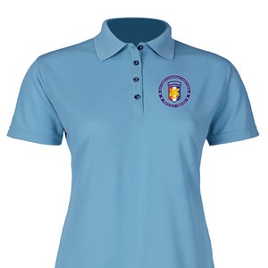 May include: A light blue polo shirt with a small embroidered patch on the right chest. The patch is a circle with a star on each side and the words "Southern European Task Force" and "Proudly Served" around the edge. Inside the circle is a shield with a yellow eagle and a red and white flag.