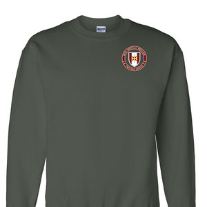 May include: A dark green sweatshirt with a red and gold embroidered patch on the left chest. The patch reads "4th Medical Brigade Proudly Served".