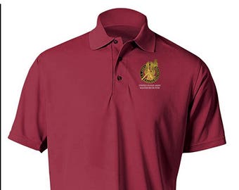 May include: A maroon polo shirt with a gold embroidered patch featuring the United States Army Master Recruiter insignia.