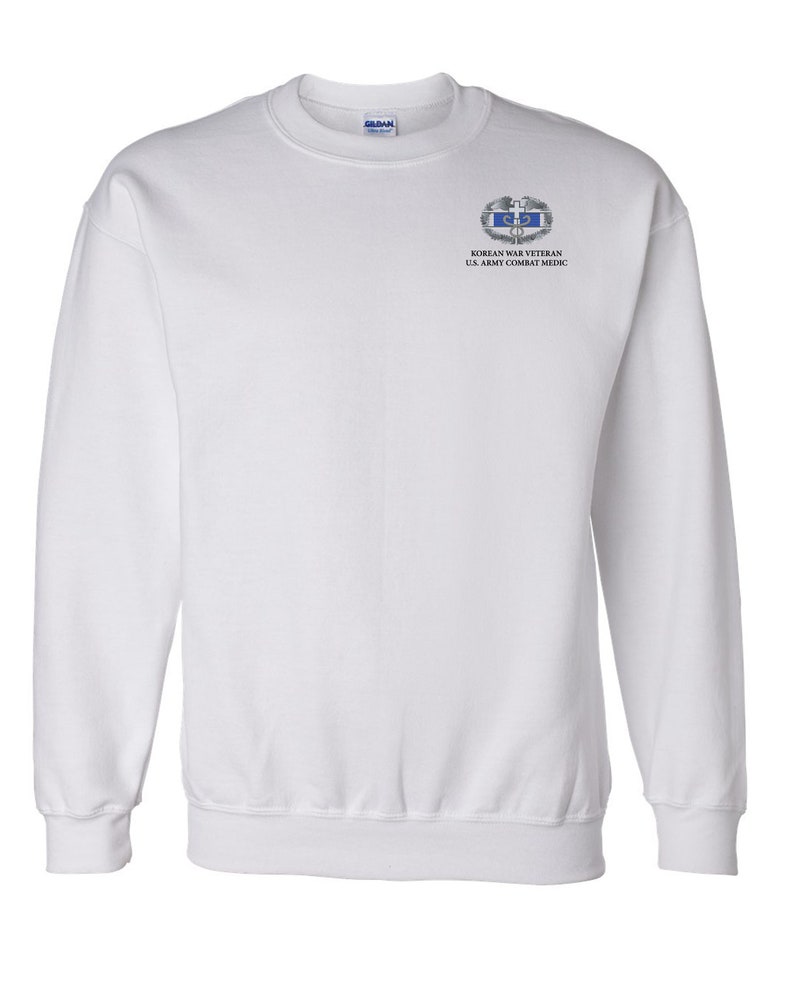May include: White sweatshirt with a Korean War Veteran U.S. Army Combat Medic patch on the left chest.