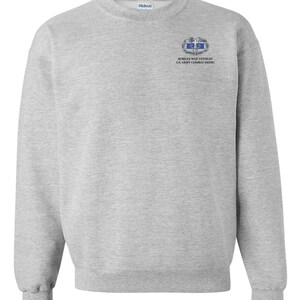 May include: A gray sweatshirt with a Korean War Veteran U.S. Army Combat Medic patch on the left chest.