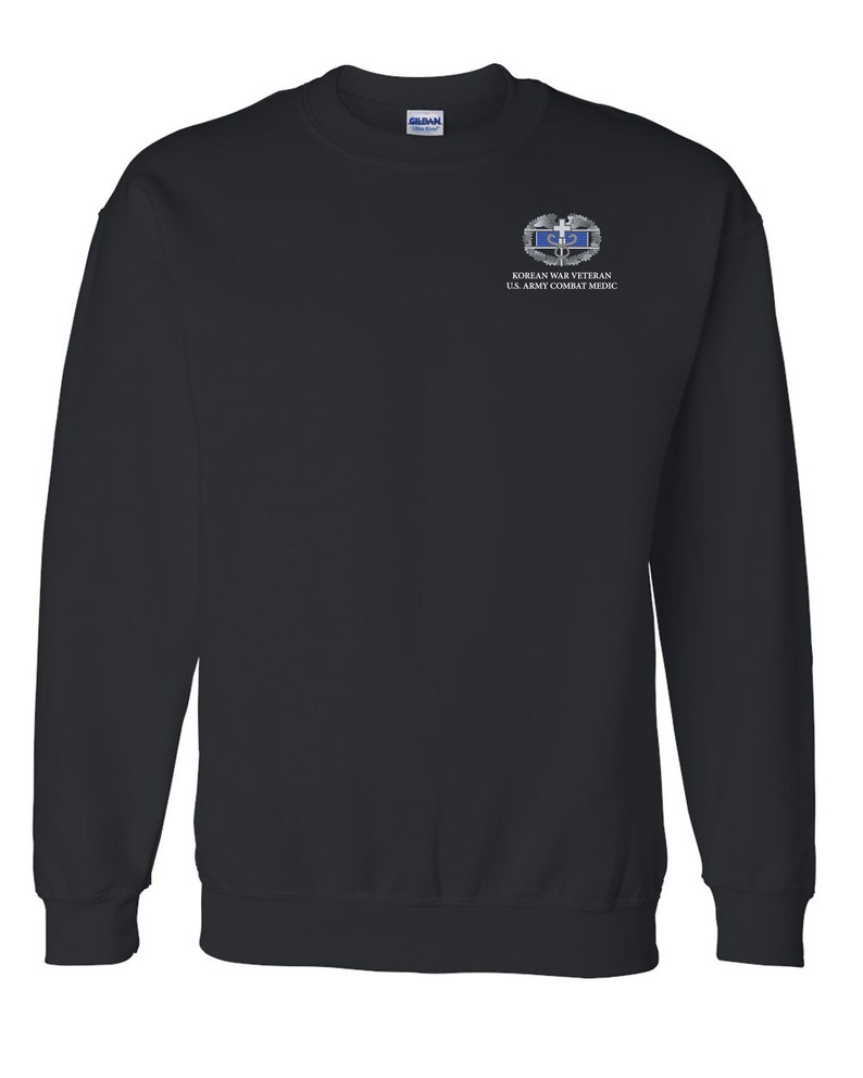 May include: Black sweatshirt with a Korean War Veteran U.S. Army Combat Medic patch on the left chest.