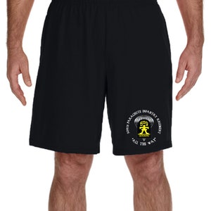 May include: Black athletic shorts with a white graphic of the 509th Parachute Infantry Regiment logo. The logo features a parachute, a soldier, and the text "Geronimo" and "All the Way".