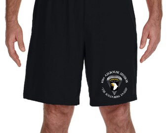 Może przedstawiać: Czarne sportowe spodenki z białym nadrukiem logo 101. Dywizji Powietrznodesantowej, które zawiera tekst "101st Airborne Division The Screaming Eagles".