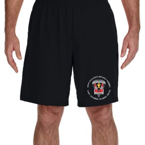 May include: Black athletic shorts with a white circle logo featuring a parachute, a soldier, and the text "509th PARACUTE INFANTRY REGIMENT ALL THE WAY JOINT READINESS TRAINING CENTER".