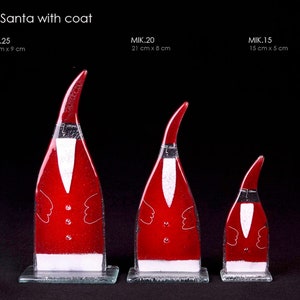 Santa Claus with coat fused glass statue. Available sizes 15 cm, 21 cm and 25 cm high.  All our products are handcrafted fusion glass.