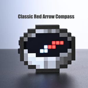 May include: A pixelated compass with a red arrow design and the text "Classic Red Arrow Compass". The compass has a black background with red and white illuminated squares. The compass is gray and black.