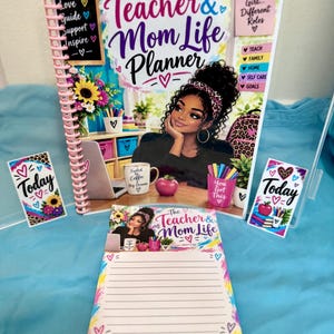 May include: A spiral-bound planner titled The Teacher & Mom Life Planner featuring an illustration of a person with curly hair, a desk with a laptop, coffee mug, and stationery. Includes two matching Today note cards and a lined notepad.