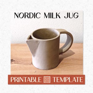 May include: A beige ceramic milk jug with a handle and a spout. The words "NORDIC MILK JUG" are printed above the jug. Below the jug, the words "PRINTABLE TEMPLATE" are printed on a brown banner.