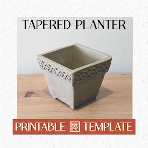 May include: A square, tapered planter with a decorative border. The planter is a light grey colour and features the text "TAPERED PLANTER" at the top and "PRINTABLE TEMPLATE" at the bottom.