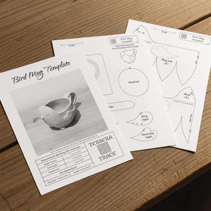 May include: A white paper Bird Mug Template featuring a black and white photograph of a bird-shaped mug, technical line drawings of mug components, and a measurement table listing dimensions in inches and centimeters for the finished ceramic piece.