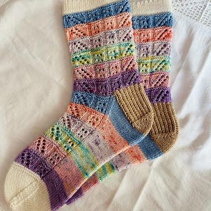 May include: A white ceramic mug with a black handle and the text "But First, Coffee" in a black, bold font. The mug is on a white surface. The mug is approximately 4 inches tall.