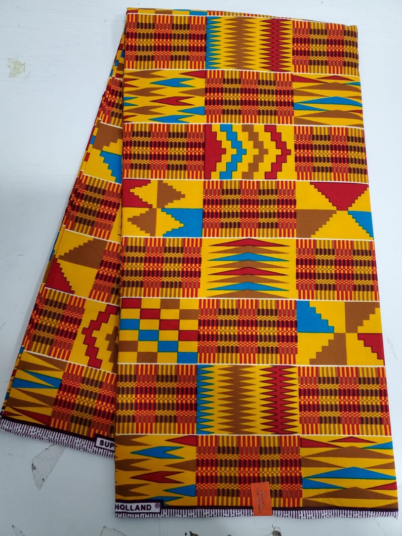 May include: A yellow, red, blue, and brown patterned fabric with a geometric design. The fabric has the text "Holland" printed on the bottom edge.