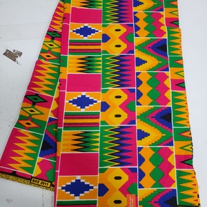 May include: A colorful fabric with a geometric pattern in shades of yellow, green, blue, pink, and black. The fabric has a repeating pattern of squares and triangles. The fabric is labeled "SKE 2011".