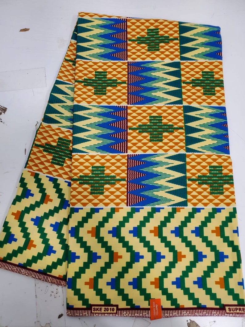 May include: A yellow, green, blue, and orange patterned fabric with the text "SKE 2010" and "SUPER" printed on the bottom edge.