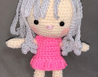 Small crochet doll with silver grey hair and pink dress