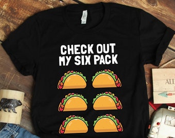 May include: Black t-shirt with the text "CHECK OUT MY SIX PACK" and six cartoon tacos in a row.