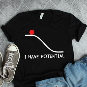 May include: Black t-shirt with a white graphic of a red ball at the top of a hill with the text "I HAVE POTENTIAL" underneath.