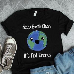 May include: Black t-shirt with a white graphic of a smiling cartoon Earth with the text "Keep Earth Clean It's Not Uranus".